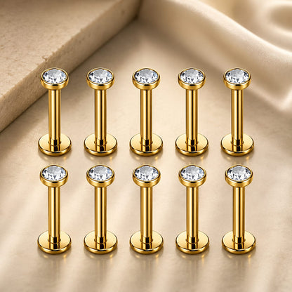 Assortiment de 10 piercings aux finitions variées : or jaune classique, argenté moderne, pierres noires au style rock et cristaux transparents scintillants.