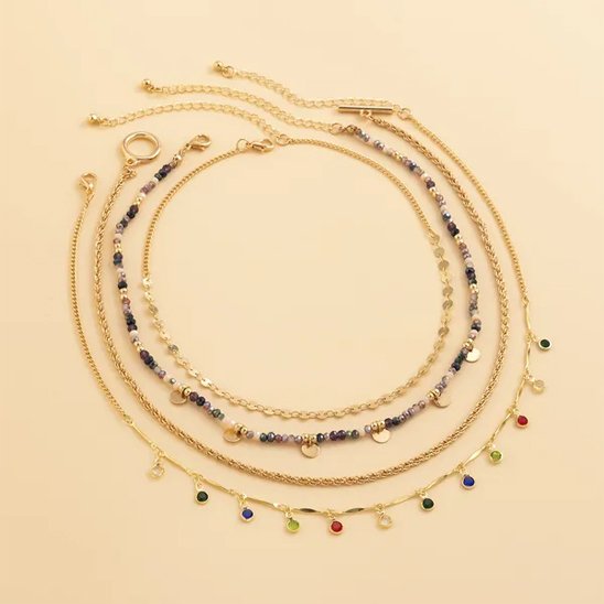 Collier layering doré avec anneau central et perles polies