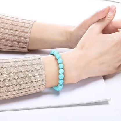Bracelet femme en perles turquoise bleu ciel et blanc marbré, élastique souple pour un confort optimal et un style naturel.